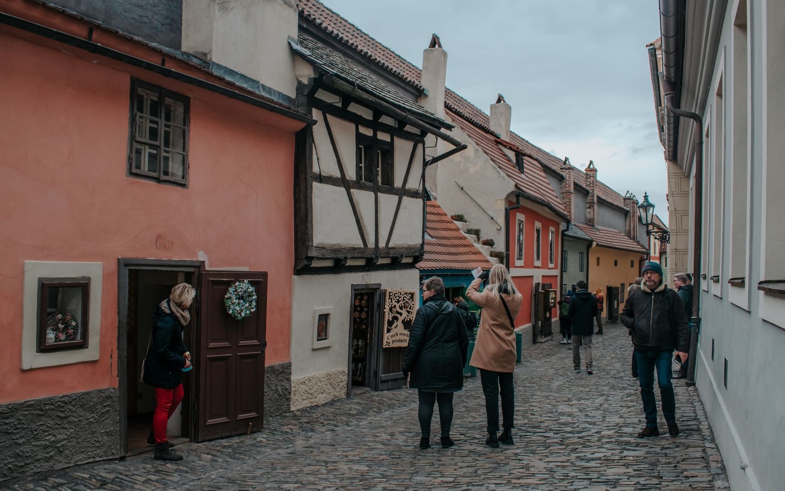 People walking along Prague Castle's Golden Lane